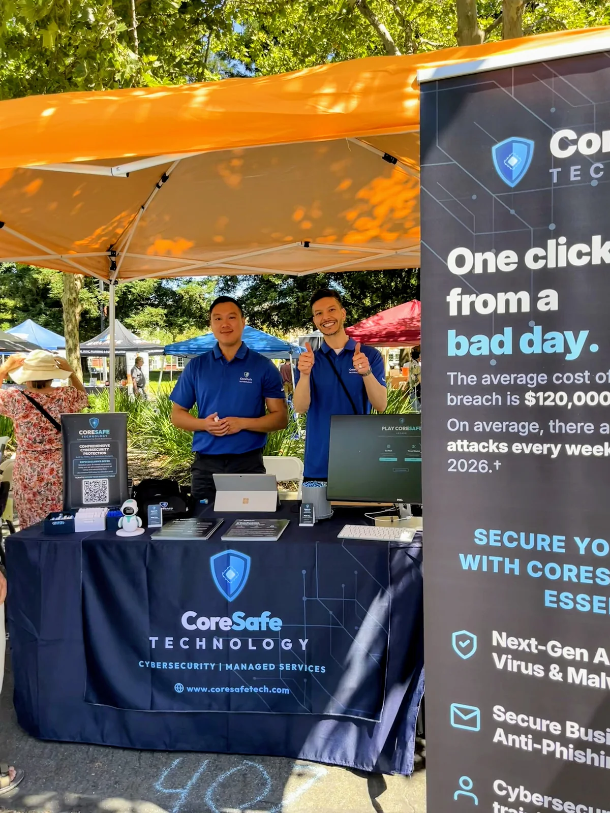 CoreSafe Technology team standing behind their community expo booth