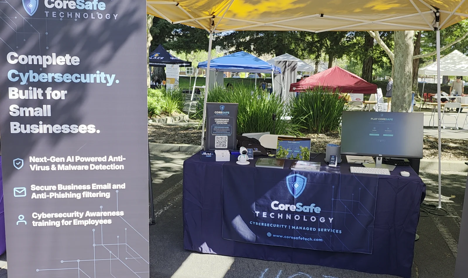 Wide still frame showing the CoreSafe Technology expo booth and cybersecurity display