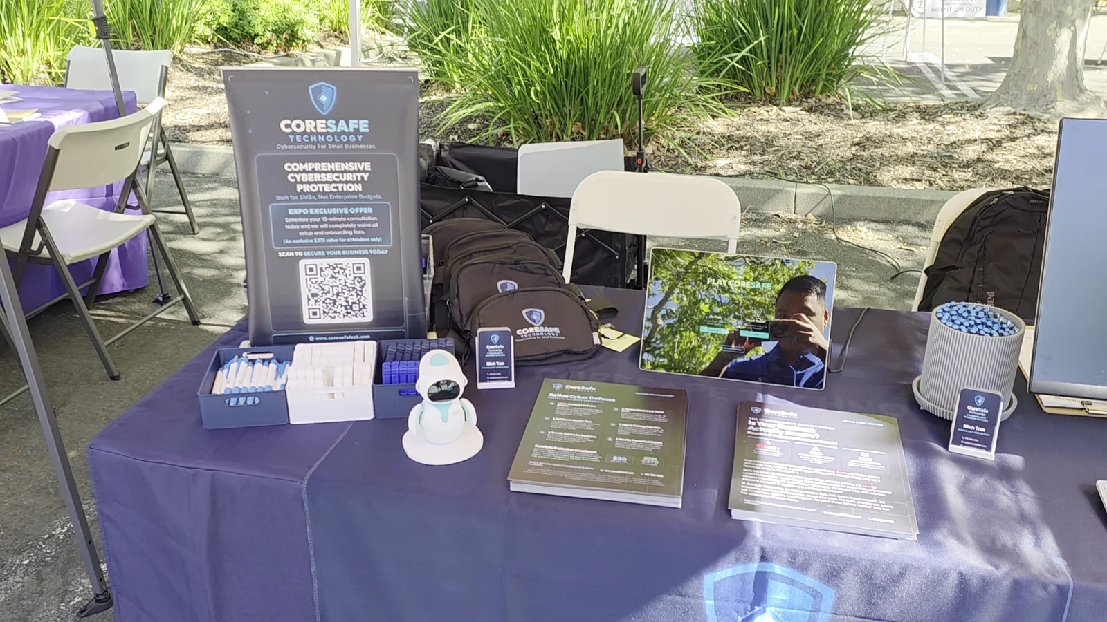 Still frame showing CoreSafe Technology cybersecurity materials and booth display